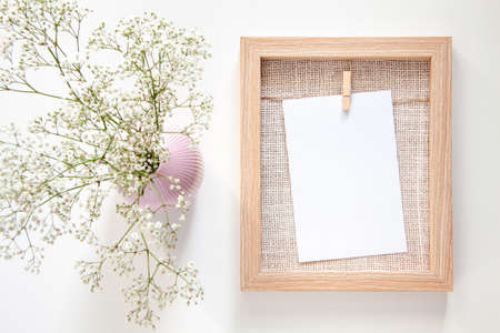 Wooden mockup with white wildflowers in a pink vaseの写真素材