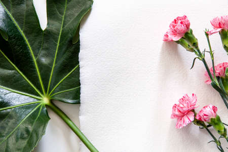 Copy space from handmade paper with pink flowers and green leaf