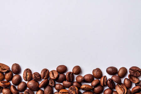 Background from organic horizontal spilled coffee arabica in beans with white space for text