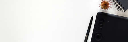 White office desk with graphic tablet. Office supplies. Copy space. Widescreen photoの写真素材