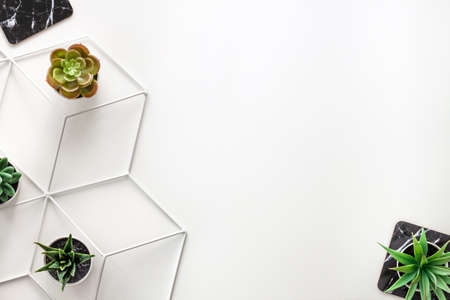 White desk. Top view copy space for text. Succulents, marbled pads and metal geometric table. Hipster creative spaceの写真素材