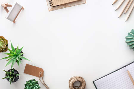 White desk with office accessories. Top view copy space for text. Succulents, string, open notebook and wooden pencils. Hipster creative spaceの写真素材