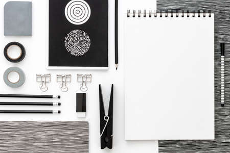 Flat lay mockup with black frame and office supplies on white background. Top view mockup. Blog template. Black and white conceptの写真素材