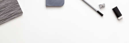 Creative desk with office supplies. Papers, notebook and felt-tip pen. Copy space for text. View from above. Panoramic black and white compositionの写真素材