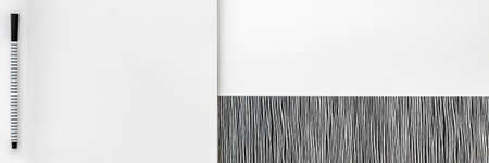 Blank spiral sketchbook with empty open page. Top view real photo. White background for text. Copy space. Black and white panoramic minimal conceptの写真素材