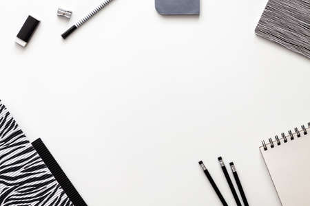 Creative desk with office supplies. Papers, notebook, sketchbook, pencils and felt-tip pens. Copy space for text. View from above. Black and white compositionの写真素材