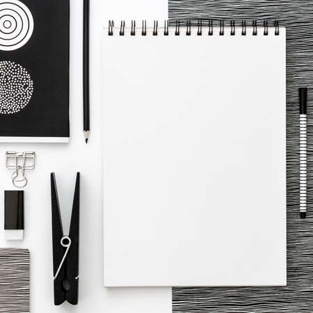 Flat lay mockup with black frame and office supplies on white background. Top view mockup. Blog template. Black and white concept. Geometrical compositionの写真素材
