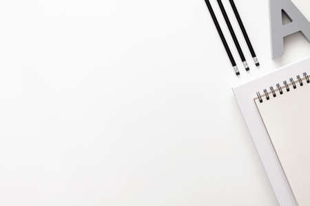 White office desk with empty space for text. Copy space. Office accessories such as pencils and notebook. View from the topの写真素材