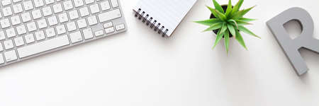 White office desk with copy space. Keyboard, notebook and succulent. View from above. Panoramaの写真素材