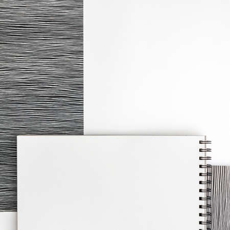 Blank spiral bound sketchbook with empty open page. Top view. White background for text. Copy space. Black and white conceptの写真素材
