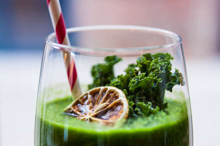 Green healthy kale cocktail with orangeの写真素材
