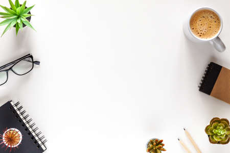 White office copy space. Home office. Office supplies, coffee, notebook. View from above.の写真素材