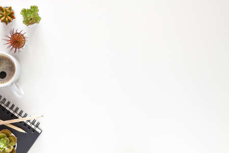 White desk at home with coffee, succulents and notebook. View from above. Copy space.の写真素材