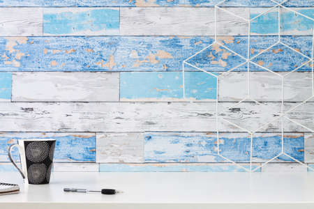Home office desk. A wall with old boards. Office items. Geometric toolbox. Copy space.の写真素材