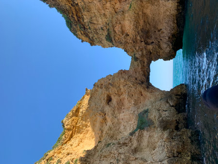 Rocky coast of Lagos with a blue sky.のeditorial素材