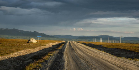 Dirt road, Flatruet leading to the horizon in Sweden, Scandinavia with mountain viewの写真素材