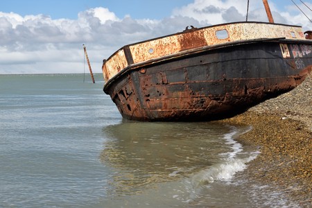 old and rusty boat grounded during the high tide