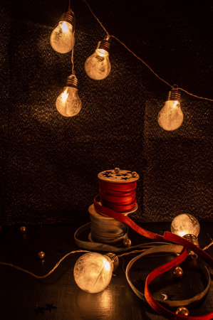Still life of velvet ribbons on a bobbin and chirstmas light bulbsの写真素材