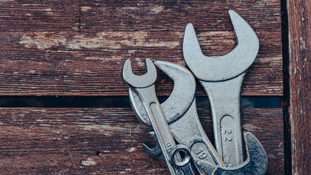 Close-up image of a set of wrenches on a wooden tableの写真素材