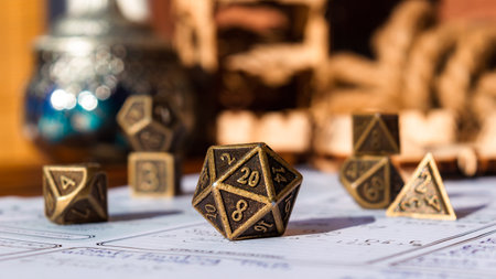 Close-up image of a metallic 20-sided die within the background polyhedral diceの写真素材