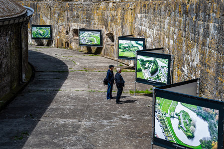 PAMPUS, THE NETHERLANDS - JUNE 10, 2022: Two men looking at images about other fortressesのeditorial素材