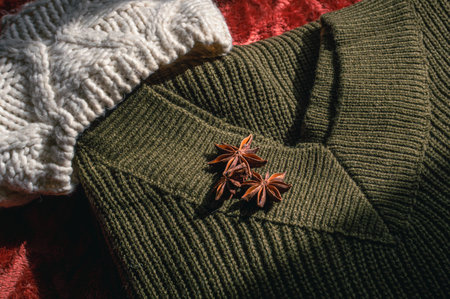 Image of an army green woolen sweater and a woolen hat in the sunlightの写真素材