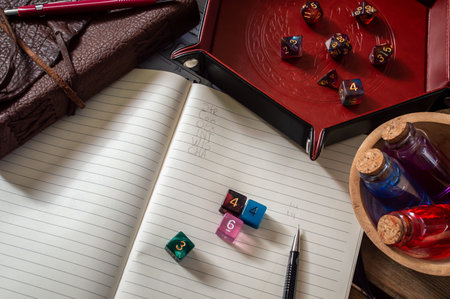 Overhead image of colorful regular dice on a note book used for rolling character stats.