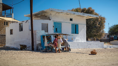 Plati, Greece 15 September, 2022: two women browsing at a sponge stall on the beachのeditorial素材
