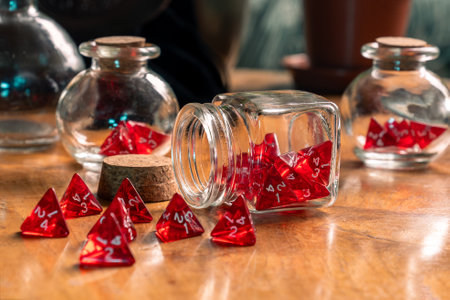 Spilled red dice from a glass jar on a rustic wooden table, capturing a moment of gaming in elegant disarrayの写真素材