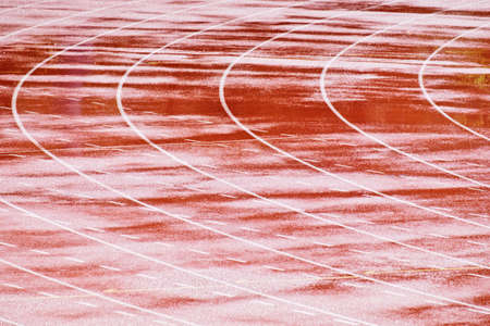 Heavy rain drops falling on race running trackの写真素材