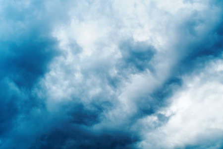 Dark, black clouds in the sky during summer.の写真素材