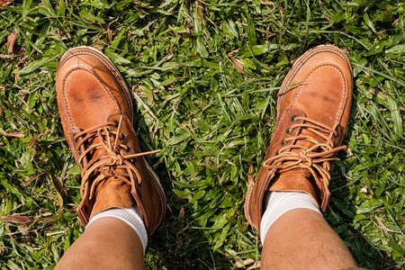 Top view of brown shoes on grass fieldの写真素材