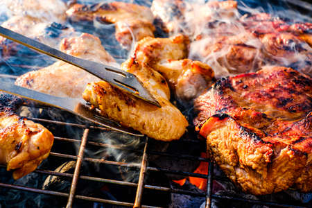 Cooking barbecue meat on an open fireの写真素材