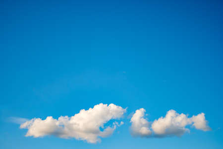 Blue sky background with a tiny clouds