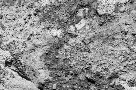 Old concrete wall with cracks and scratches in black and white. Abstract background and texture for design.の写真素材