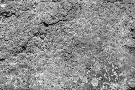 Background texture of stone with cracks and scratches. Monochrome.の写真素材