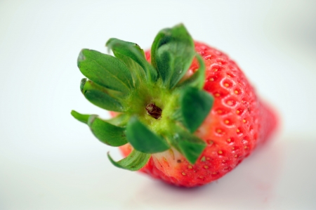 Strawberry with leaves isolated on whiteの写真素材
