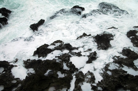White surf on black stones