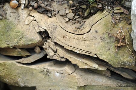 damaged rock in a wall with lots of cracksの写真素材