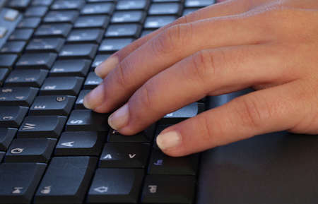 Woman hand over keyboard