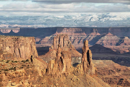 Girl at Mesa Arch in Canyonlands National Park near Moab, Utah, USAの写真素材