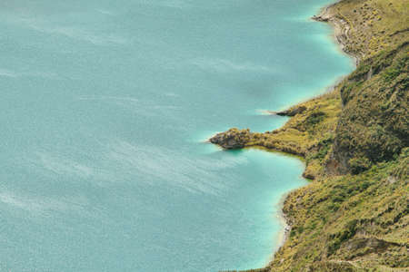 Amazing view of  lake of the Quilotoa caldera. Quilotoa is the western volcano in Andes range and is located in andean region of Ecuador.の写真素材