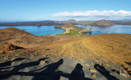 Silhouettes of tourist people photographing the amazing landscape of pinnacle Rock and surroundings in Bartolome island, Galapagos, Ecuadorの写真素材