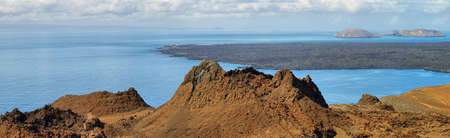 Volcanic landscape in Bartolome island and Santiago island at background, Galapagos, Ecuadorの写真素材