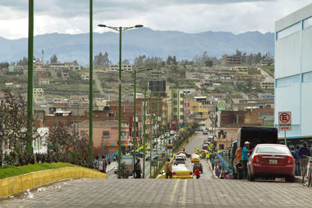 LATACUNGA, ECUADOR - APRIL 18: Ecuadorian ethnic people and traffic in te street on April 18, 2014 in Latacunga, Ecuador.のeditorial素材