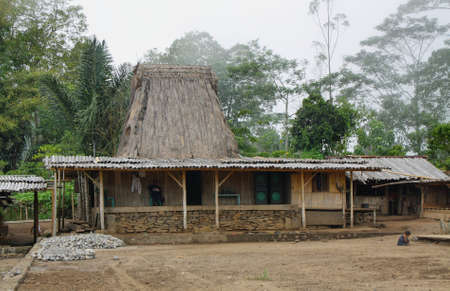 FLORES, INDONESIA - September 22: people at the entrance of a house in indigenous traditional village of Wogo on September 22, 2009 in Flores Indonesia.のeditorial素材