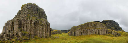 Dverghamrar sea eroded basaltic columns in South Iceland. Waterfall,.Foss a Sidu in the background.の写真素材