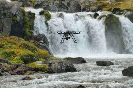 Little quadcopter flying around Dynjandi waterfall in Westfjords, Icelandの写真素材