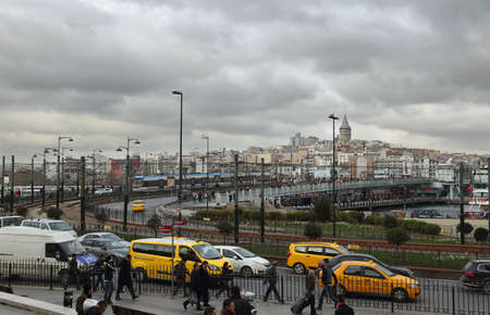 ISTANBUL, TURKEY - NOVEMBER 27: View of the hectic daily life, yellow cabs and famous Galata Bridge on November 27, 2014 in the historical center of Istanbul, Turkey.のeditorial素材