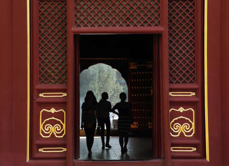 Silhouettes of girls inside Lama Temple Yonghe Lamasery in Beijing, China.のeditorial素材